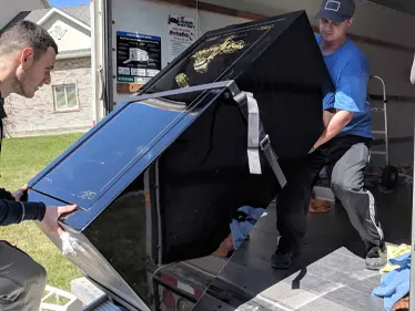 professional gun safe movers - Manly Moving crew loading a gun safe to a truck